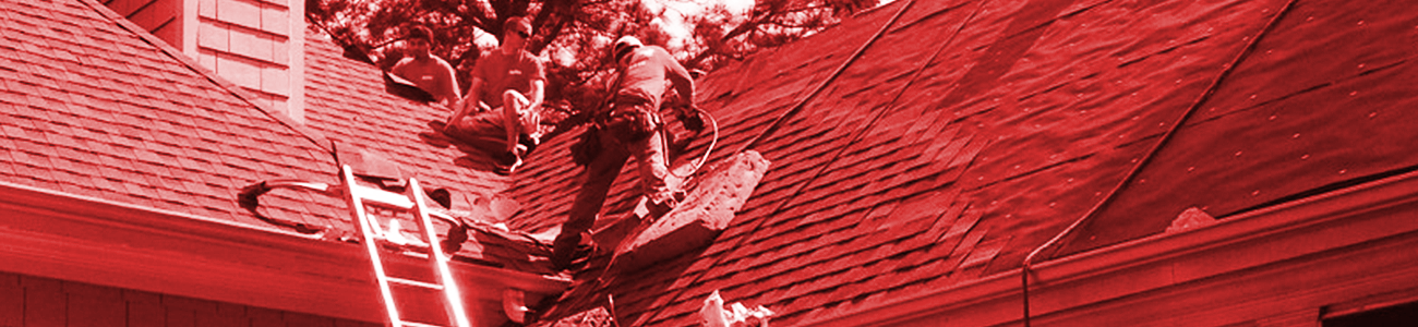 Three workmen working on a roof