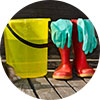 Bucket filled with water, a pair of rain boots and rubber gloves