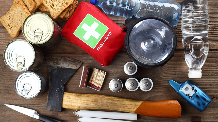 Cyclone survival kit consisting of water, batteries, first aid kit, hatchet, matches, radio, canned food, bread, candles