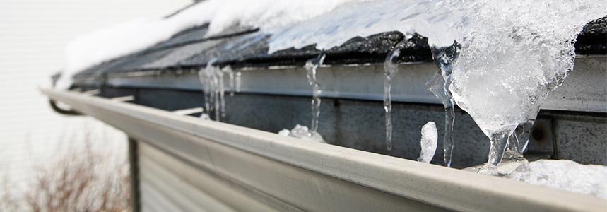 Water and ice going into a gutter.