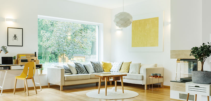 A contemporary modern living room with pops of mustard as an accent color.